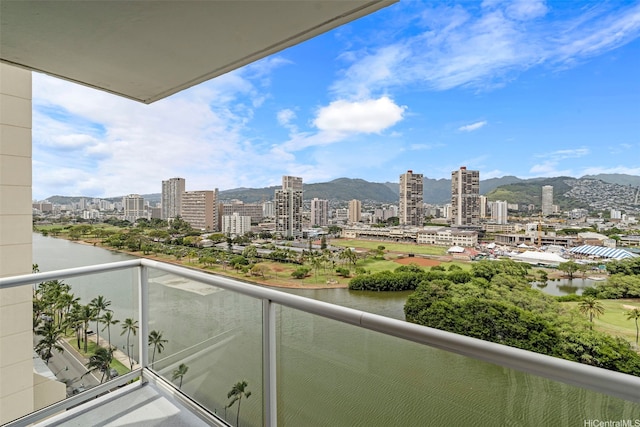 balcony with a view of city and a water and mountain view