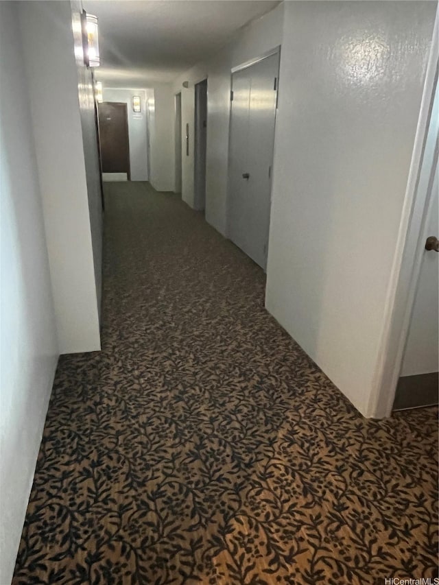 hall featuring speckled floor