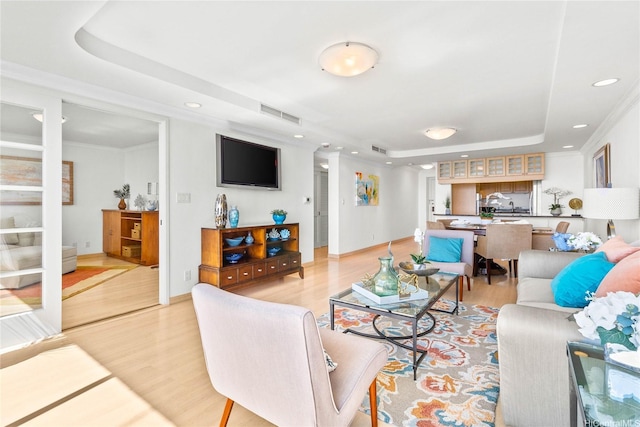 1600 Ala Moana Blvd Unit 2406, Honolulu, HI 96815 - living area with a raised ceiling, light wood finished floors, recessed lighting, baseboards, and crown molding