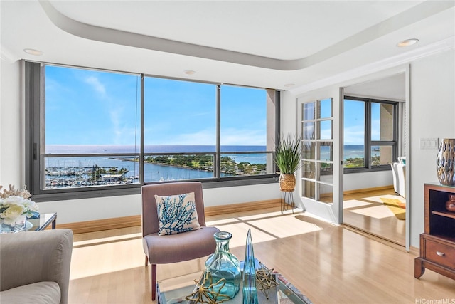 1600 Ala Moana Blvd Unit 2406, Honolulu, HI 96815 - living room featuring a water view, wood finished floors, baseboards, recessed lighting, and a raised ceiling