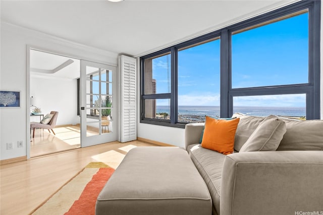 1600 Ala Moana Blvd Unit 2406, Honolulu, HI 96815 - living room featuring wood finished floors, baseboards, crown molding, and a water view