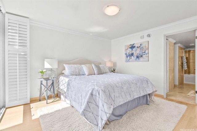 1600 Ala Moana Blvd Unit 2406, Honolulu, HI 96815 - bedroom featuring crown molding, wood finished floors, baseboards, and connected bathroom