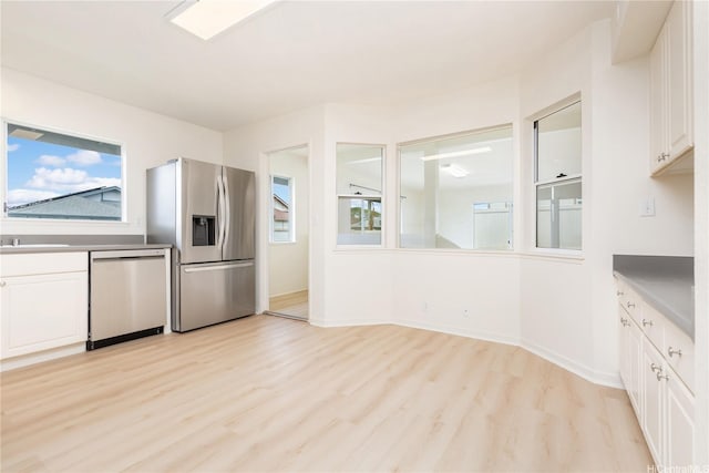 95-1090 Puneki St, Mililani, HI 96789 - kitchen with appliances with stainless steel finishes, white cabinetry, light wood-type flooring, and baseboards