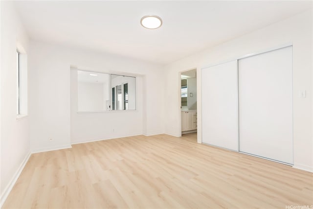 95-1090 Puneki St, Mililani, HI 96789 - unfurnished bedroom with light wood-type flooring, baseboards, and a closet