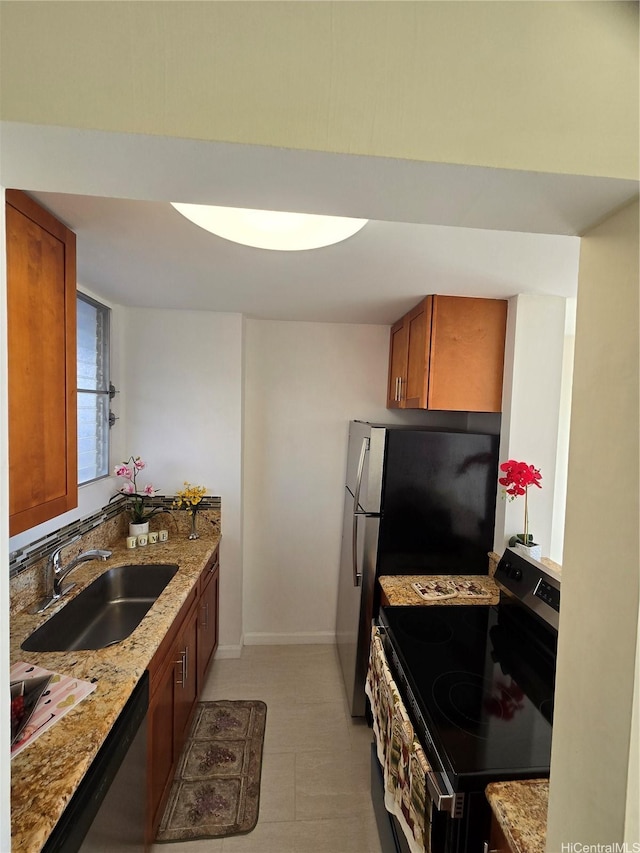 1535 Pensacola St Unit 36, Honolulu, HI 96822 - kitchen with appliances with stainless steel finishes, a sink, brown cabinets, and light stone counters