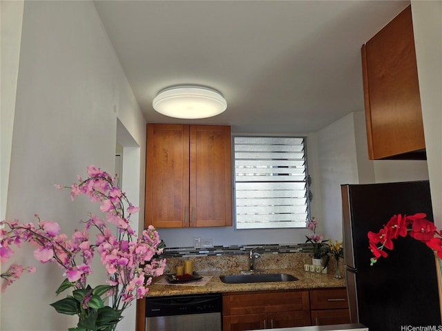 1535 Pensacola St Unit 36, Honolulu, HI 96822 - kitchen with appliances with stainless steel finishes, a sink, brown cabinets, and light stone counters