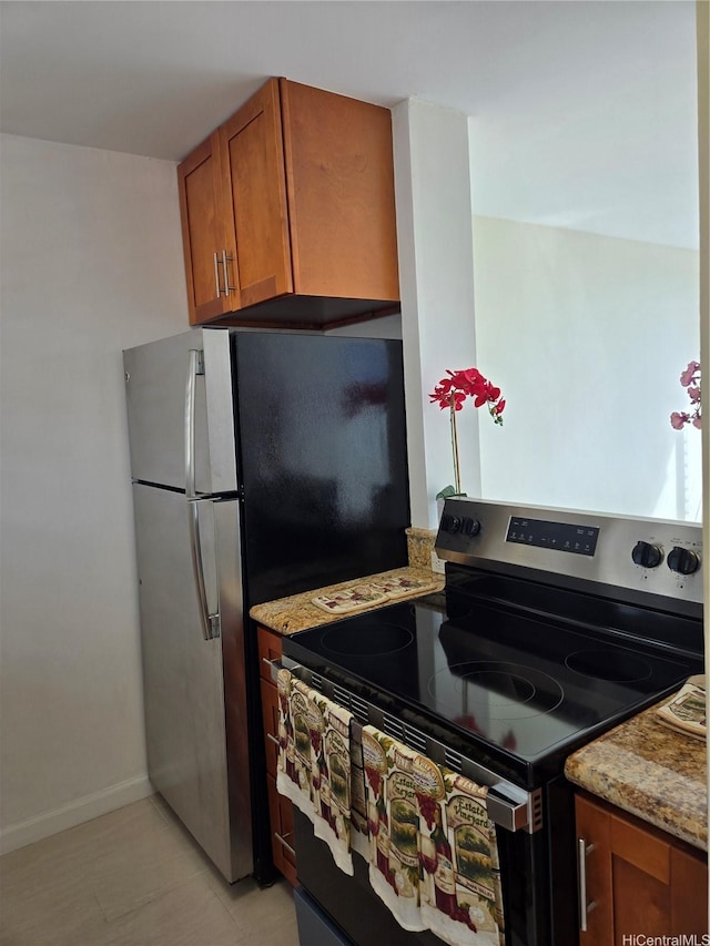 1535 Pensacola St Unit 36, Honolulu, HI 96822 - kitchen featuring stainless steel electric stove, brown cabinetry, light stone countertops, and baseboards