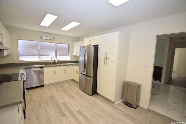 3152 Mokihana Sts, Honolulu, HI 96816 - kitchen with stainless steel appliances, a sink, white cabinets, baseboards, and under cabinet range hood