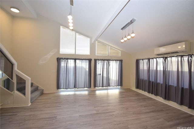 3152 Mokihana Sts, Honolulu, HI 96816 - unfurnished living room with a wall mounted AC, wood finished floors, stairway, and high vaulted ceiling