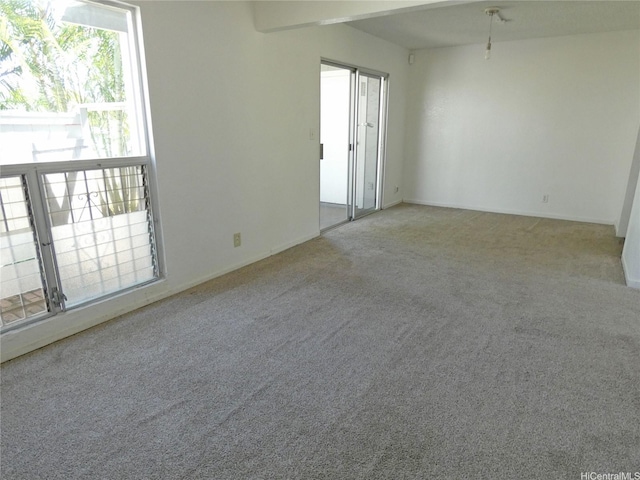 empty room with baseboards and carpet flooring
