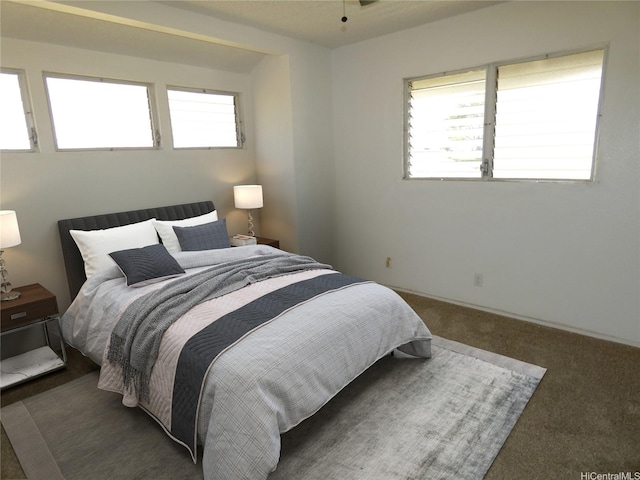bedroom with carpet and multiple windows