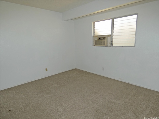 empty room with baseboards, carpet, and cooling unit