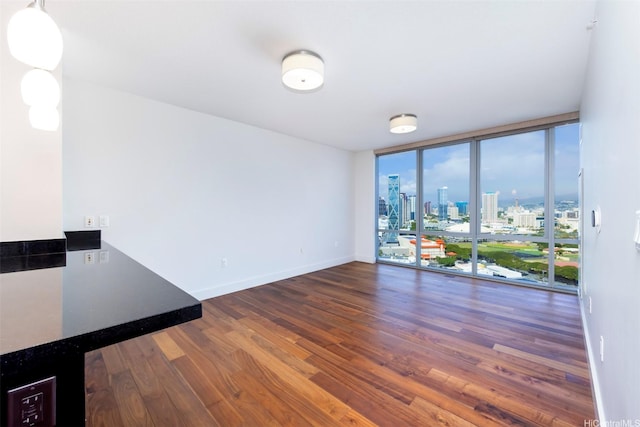 1189 Waimanu St Unit 2308, Honolulu, HI 96814 - interior space featuring baseboards, a city view, expansive windows, and wood finished floors