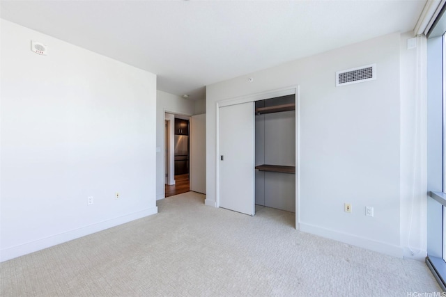 1189 Waimanu St Unit 2308, Honolulu, HI 96814 - unfurnished bedroom featuring baseboards, visible vents, carpet, and a closet