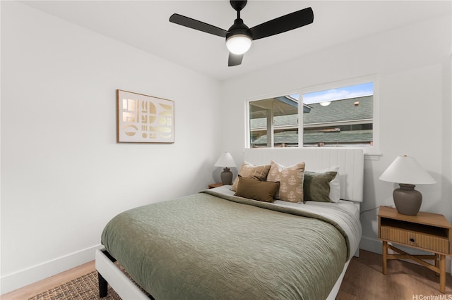 bedroom with baseboards, ceiling fan, and wood finished floors
