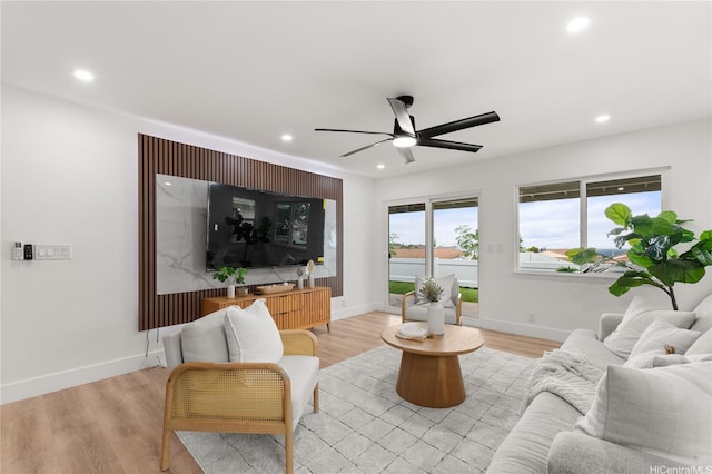 living room featuring a ceiling fan, recessed lighting, and light wood-style flooring