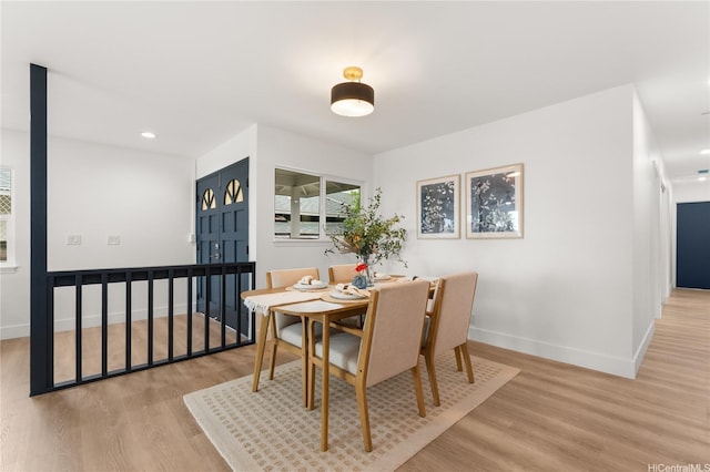 dining area featuring recessed lighting, baseboards, and wood finished floors