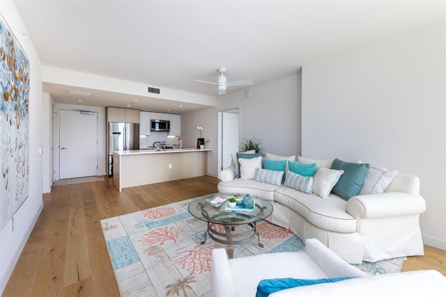1001 Queen St Unit 1804, Honolulu, HI 96814 - living room featuring light wood finished floors and a ceiling fan