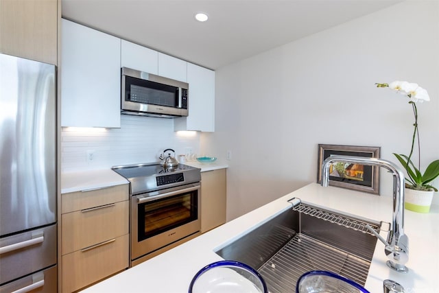 1001 Queen St Unit 1804, Honolulu, HI 96814 - kitchen featuring stainless steel appliances, light countertops, modern cabinets, a sink, and recessed lighting