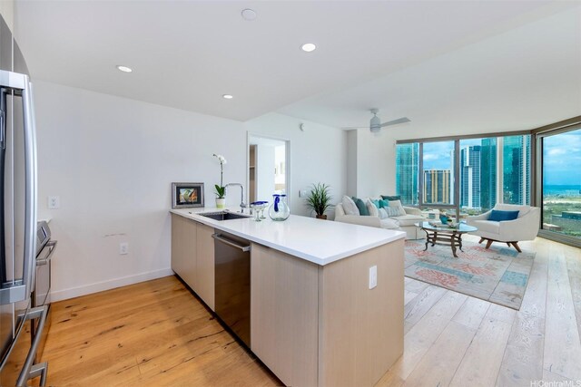 1001 Queen St Unit 1804, Honolulu, HI 96814 - kitchen with appliances with stainless steel finishes, a sink, a peninsula, open floor plan, and light wood finished floors