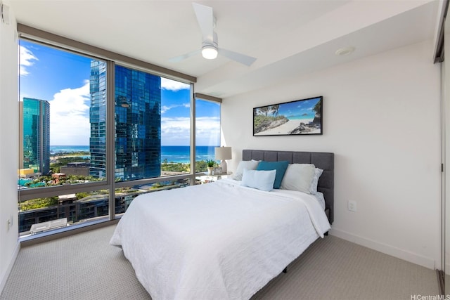 1001 Queen St Unit 1804, Honolulu, HI 96814 - bedroom featuring floor to ceiling windows, carpet, a water view, ceiling fan, and baseboards