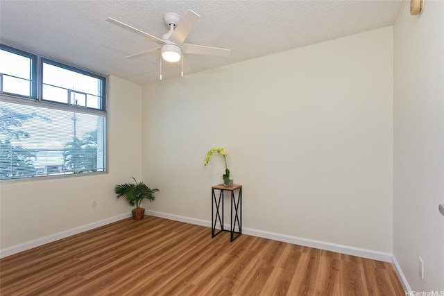 1133 Waimanu St Unit 201, Honolulu, HI 96814 - spare room with a textured ceiling, baseboards, ceiling fan, and light wood-style flooring