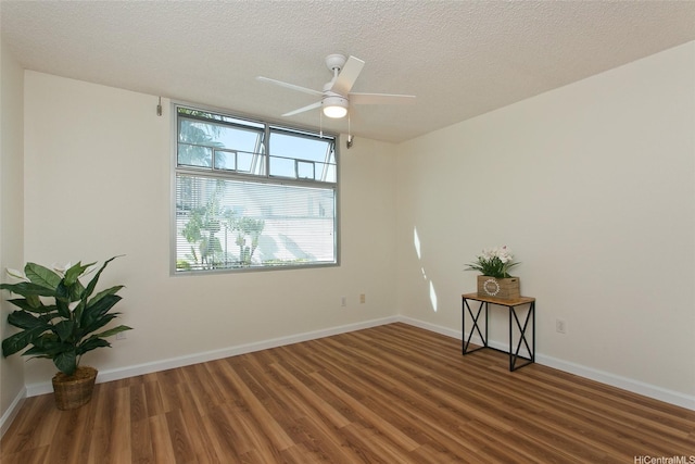1133 Waimanu St Unit 201, Honolulu, HI 96814 - spare room featuring baseboards, a textured ceiling, ceiling fan, and wood finished floors