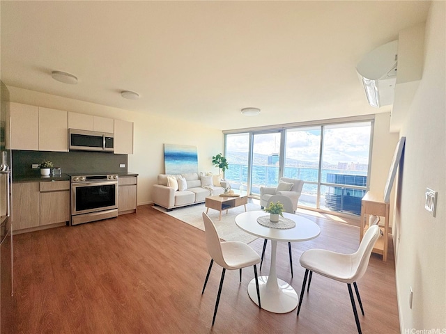 1631 Kapiolani Blvd Unit 3706, Honolulu, HI 96814 - dining space featuring light wood finished floors and expansive windows