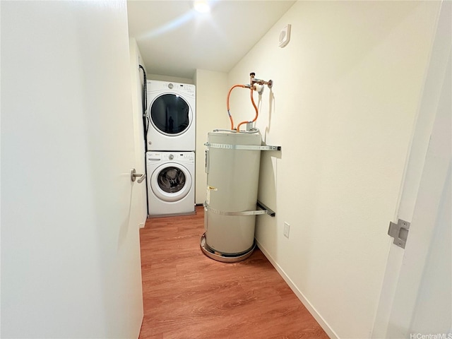 1631 Kapiolani Blvd Unit 3706, Honolulu, HI 96814 - laundry area with stacked washing machine and dryer, water heater, and light wood-type flooring