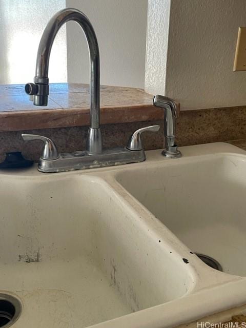room details with a textured wall and a sink