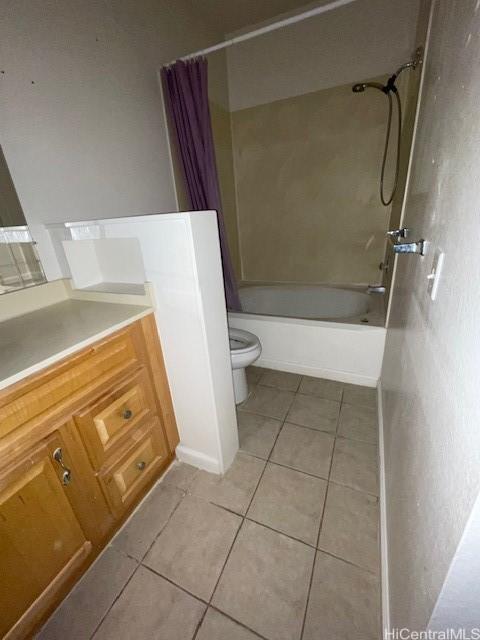 bathroom with tile patterned flooring, toilet, shower / tub combo, and vanity