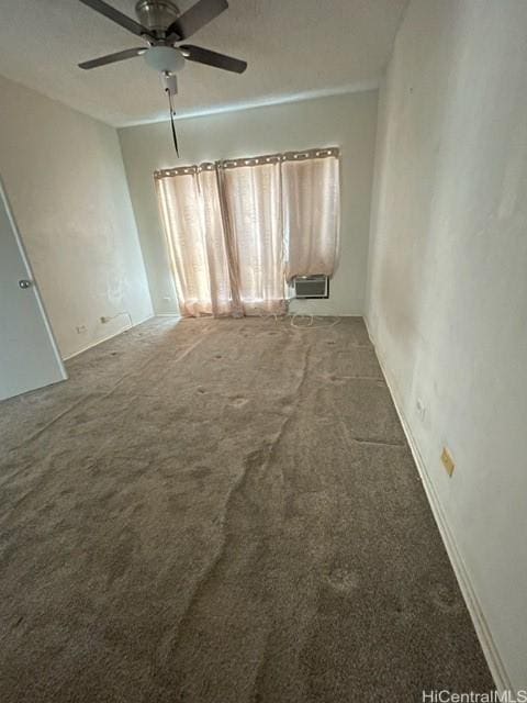 carpeted empty room with a ceiling fan