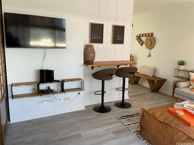 living room featuring wood finished floors and baseboards