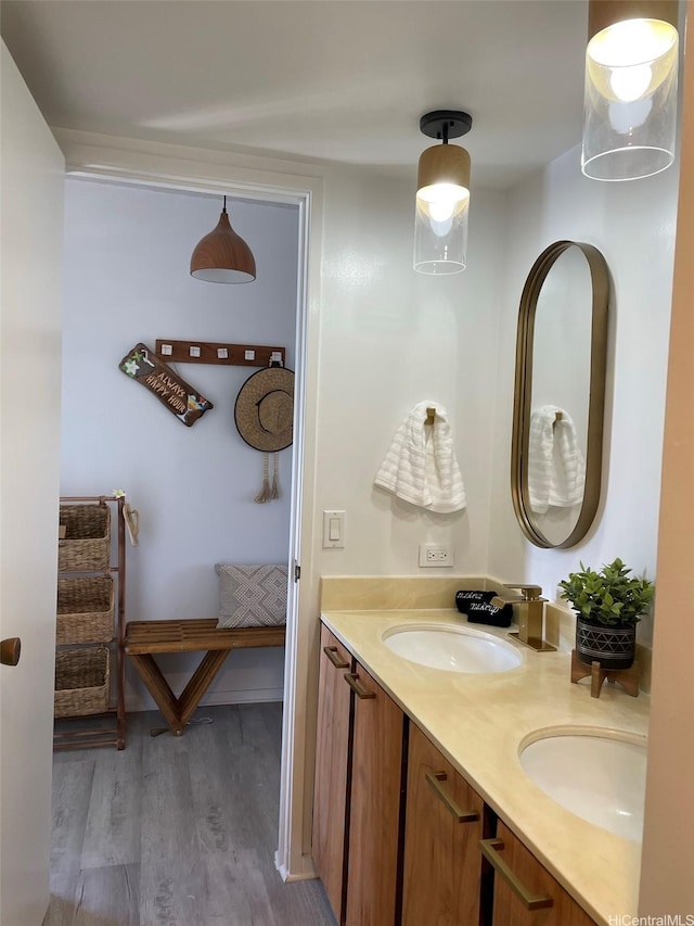 full bath featuring wood finished floors and double vanity