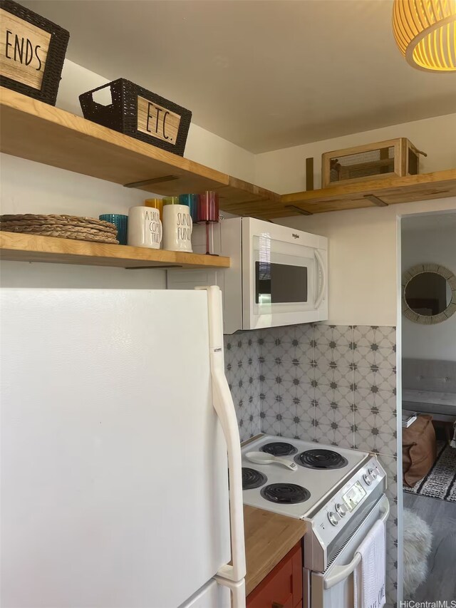kitchen featuring white appliances, open shelves, and tasteful backsplash