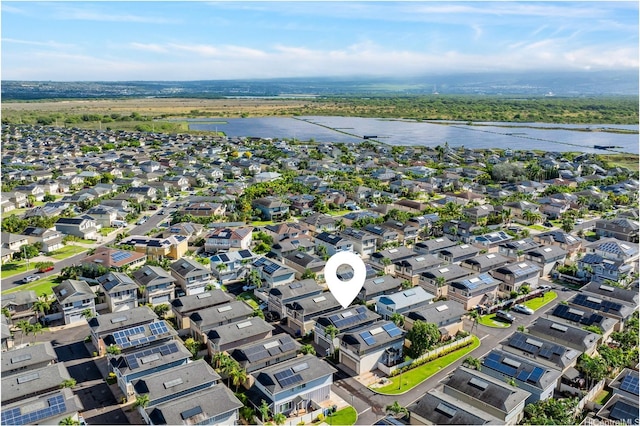view of property location featuring a nearby body of water and nearby suburban area
