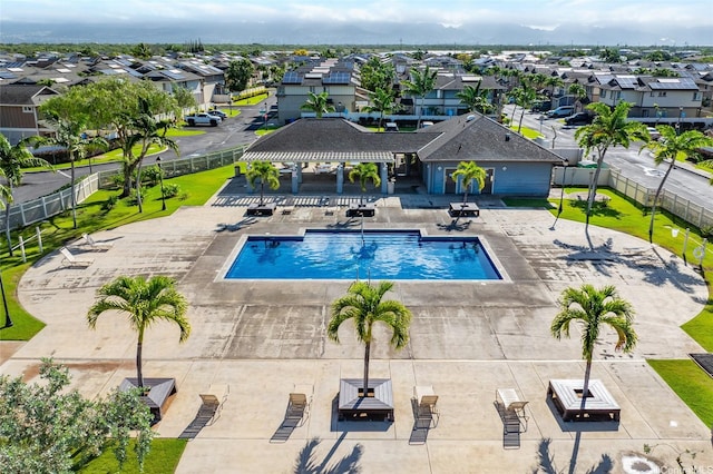 community pool with a pergola, a residential view, fence, and a patio