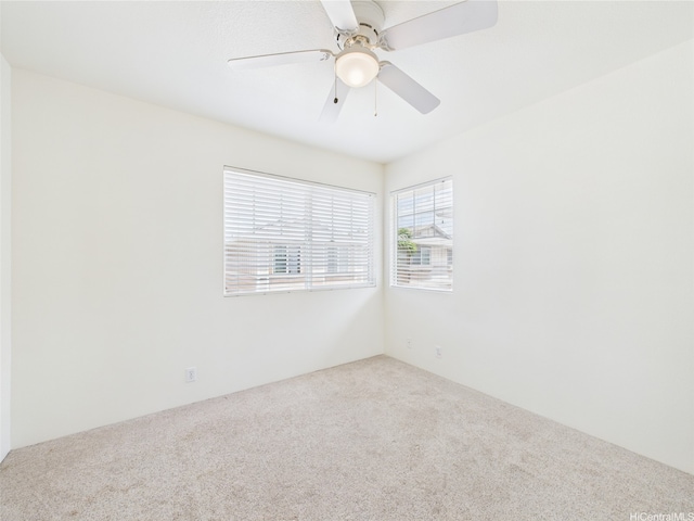 spare room featuring carpet flooring and a ceiling fan