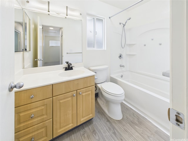 full bath featuring toilet,  shower combination, vanity, and wood finished floors