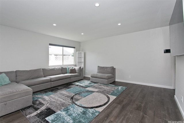 living room featuring recessed lighting, baseboards, and dark wood-style floors