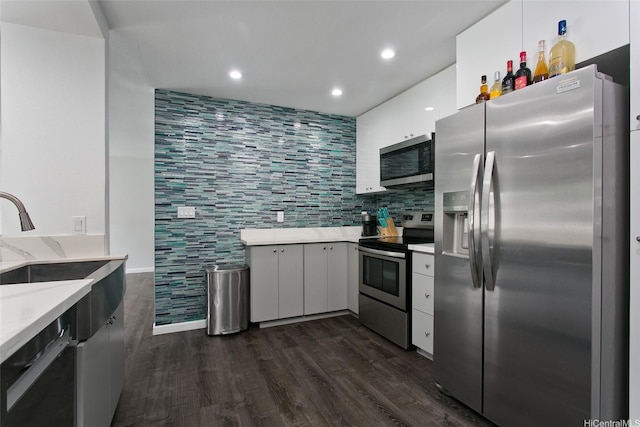 kitchen featuring light stone counters, recessed lighting, dark wood-style flooring, and appliances with stainless steel finishes
