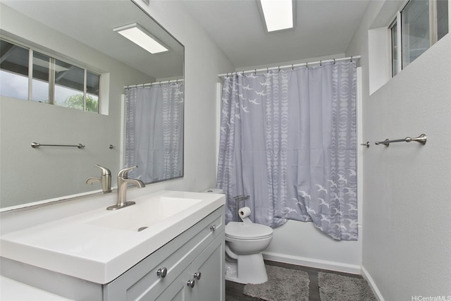 bathroom with vanity, baseboards, toilet, and wood finished floors