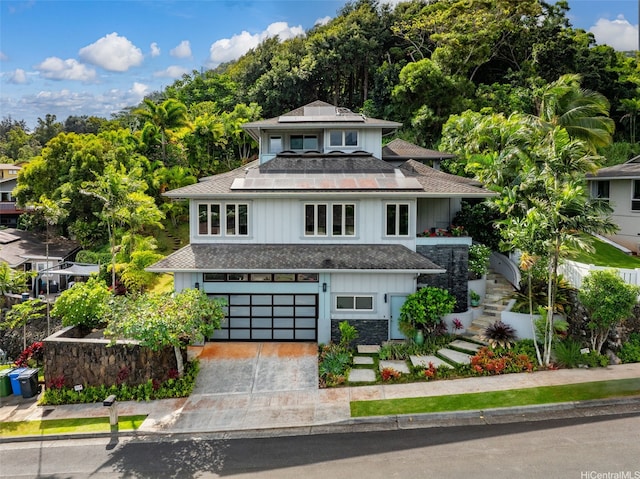 45-020 Namoku St, Kaneohe, HI 96744 - view of front of property featuring a garage, stairs, concrete driveway, a shingled roof, and board and batten siding