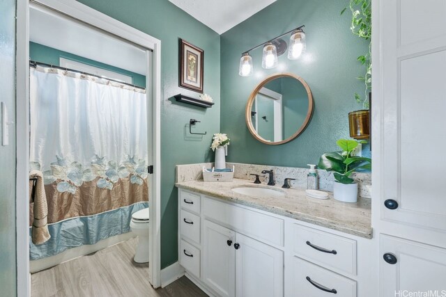 92-1288 Kikaha St Unit 78, Kapolei, HI 96707 - bathroom featuring vanity, a textured wall, wood finished floors, toilet, and a shower with shower curtain