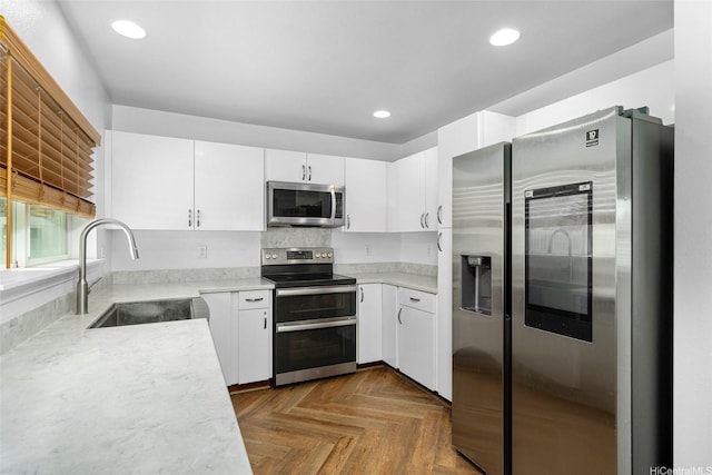 87-1847 Polikua St, Waianae, HI 96792 - kitchen with appliances with stainless steel finishes, light countertops, white cabinets, and recessed lighting
