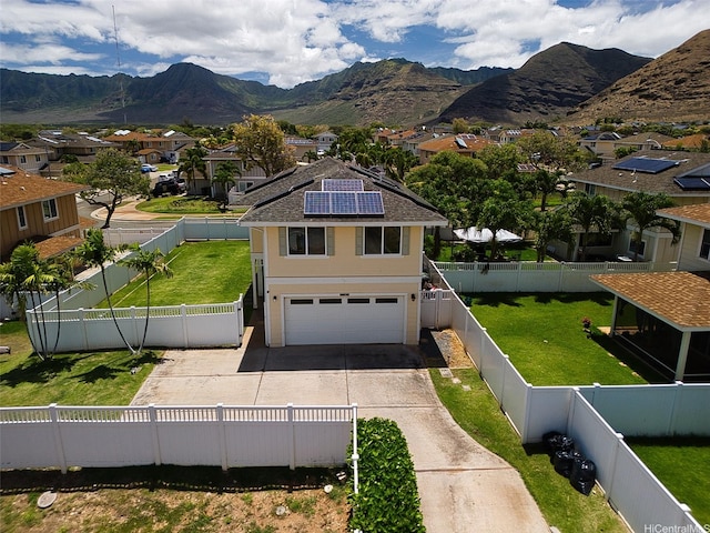 87-1847 Polikua St, Waianae, HI 96792 - view of front facade with concrete driveway, a residential view, roof mounted solar panels, a garage, and a mountain view