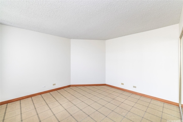 581 Kamoku St Unit 1008, Honolulu, HI 96826 - unfurnished room with baseboards and a textured ceiling