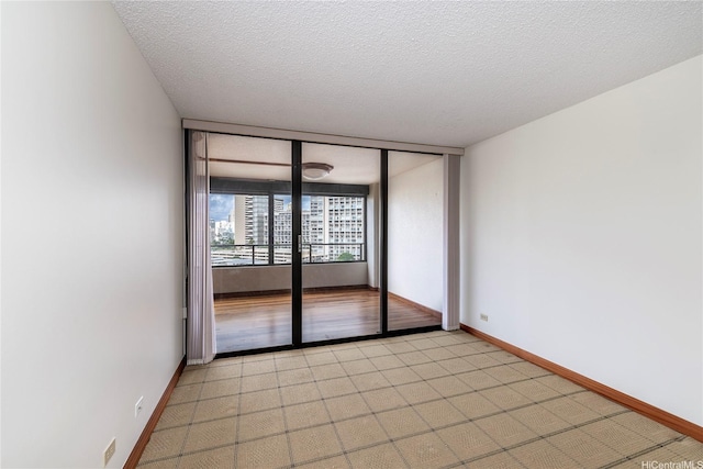 581 Kamoku St Unit 1008, Honolulu, HI 96826 - empty room with baseboards and a textured ceiling