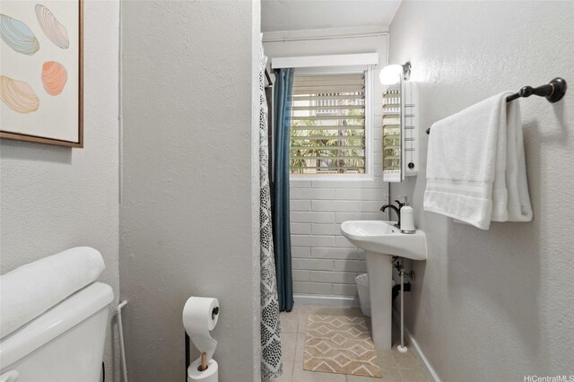 75 Kihapai St Unit 10, Kailua, HI 96734 - bathroom with tile patterned flooring, toilet, and curtained shower