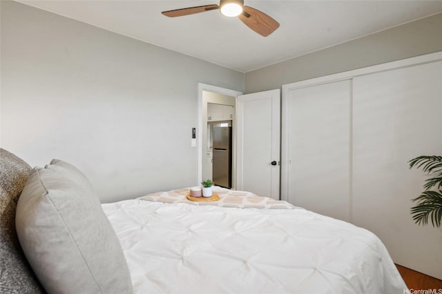 75 Kihapai St Unit 10, Kailua, HI 96734 - bedroom featuring ceiling fan, freestanding refrigerator, a closet, and wood finished floors